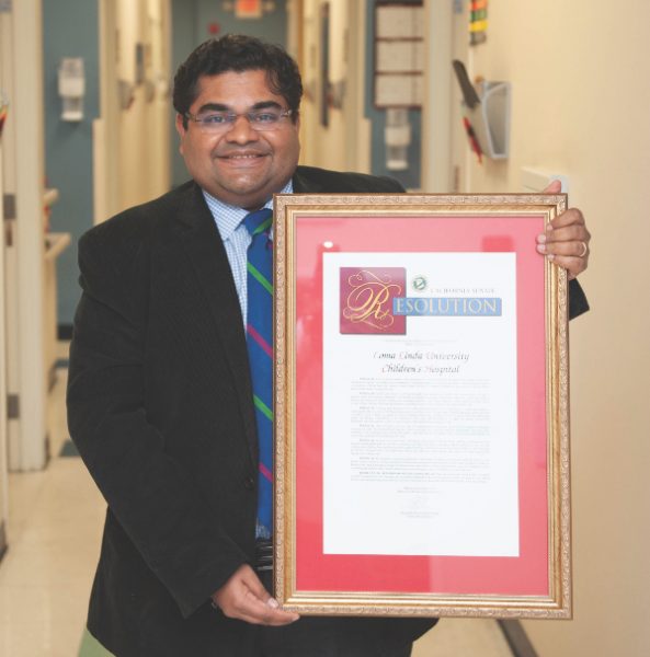 Dr. Jain holds a resolution from the California State Senate commending Children's Hospital for its comprehensive sickle cell treatment program.