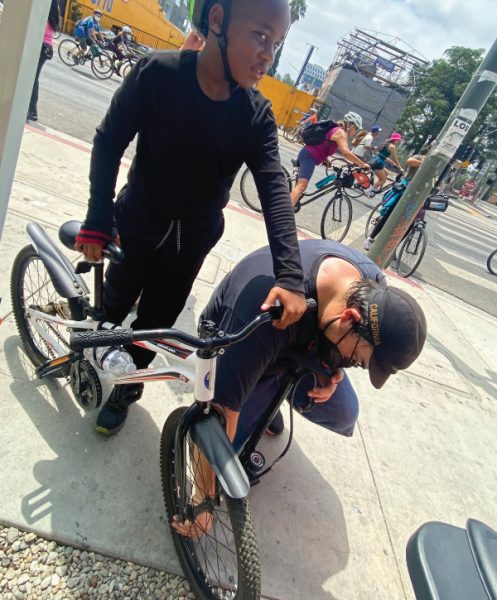 A young biker gets his tires pumped at the Hollywood church station.