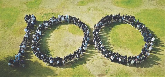 Faculty, staff, and students gather to form “100” to commemorate the centennial cohort.