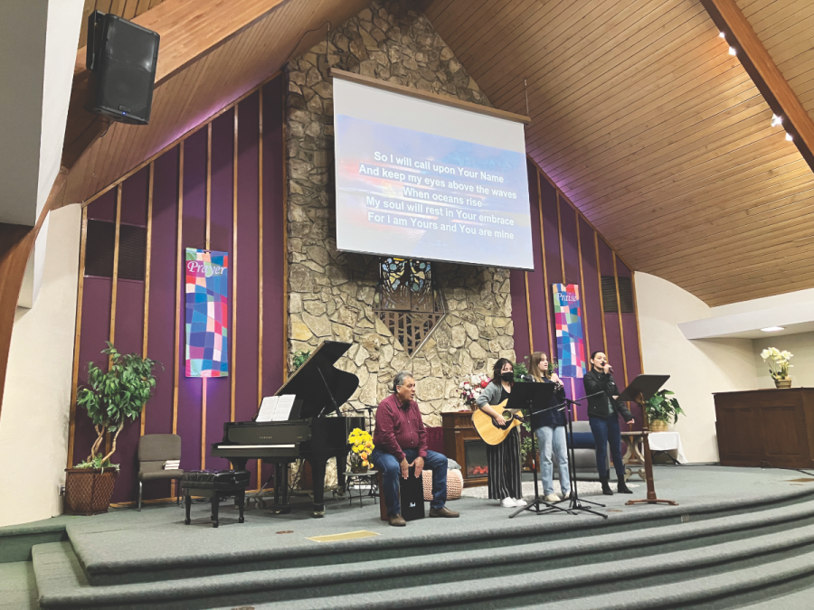 Phil (left) joins the youth praise team by playing the cajón during the week.<br />Phil (izquierda) se une al equipo de alabanza juvenil tocando el cajón durante la semana.