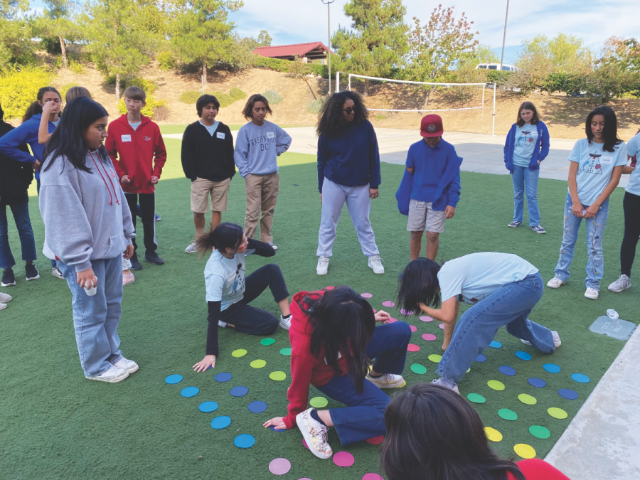 Students try not to fall in an extra-large game of Twister.