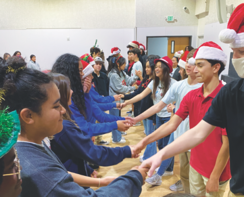 Students shake hands and break the ice with potential future high school classmates.