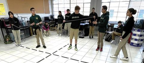 The 8th graders at Glenview Adventist Academy graphing lines on a huge grid.